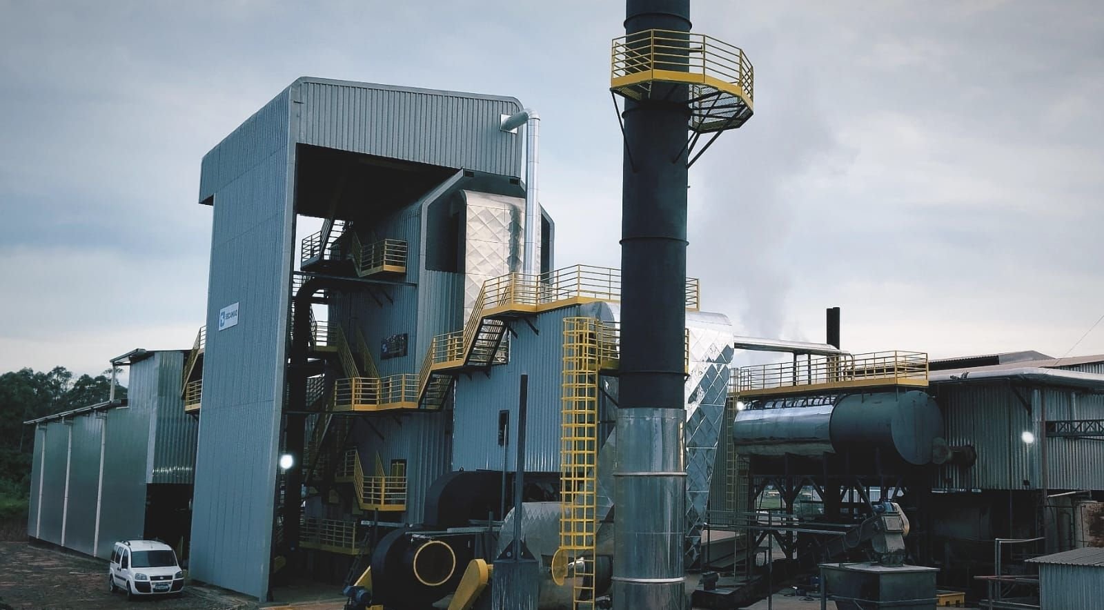 Casa de caldeira de uma planta industrial, com chaminé e plataformas